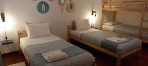 a small room with two bunk beds in it at Murta's Home in Cadaval +37 photos