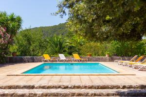a swimming pool with lounge chairs and a swimming pool at Fangar Agroturismo in Campanet
