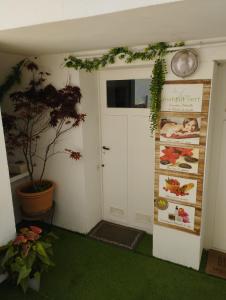 a room with a door and a plant and a sign at Villa Saint-Germain in Saint-Georges-de-Didonne