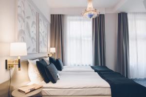a bedroom with a large bed and a chandelier at Crystal Plaza Hotel in Stockholm