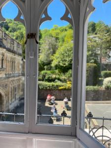 an ornate window with a view of a city at The Cafe Apartment in Great Malvern