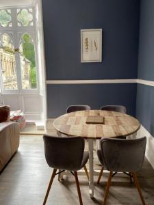 a dining room with a table and chairs at The Cafe Apartment in Great Malvern