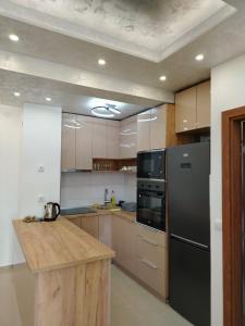 a kitchen with a black refrigerator and a counter at Apartman Branković Pirot-Zapadni Kej 58 in Pirot