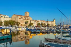 a group of boats docked in a harbor with buildings at LA MAISON DE DOMS vue mer in Cassis