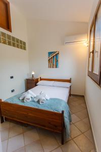 a bedroom with a bed with towels on it at SanVitoTour- Residence Il Baglio in San Vito lo Capo