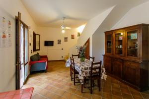 a dining room with a table and a red couch at SanVitoTour- Residence Il Baglio in San Vito lo Capo
