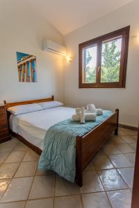 a bedroom with a bed with two towels on it at SanVitoTour- Residence Il Baglio in San Vito lo Capo