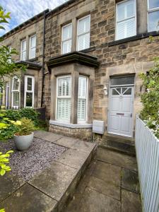 a brick house with a white door at Maison 5 in Harrogate