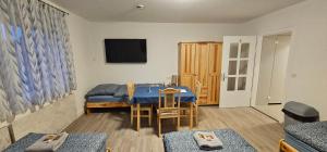 a living room with a blue table and a tv at Gasthaus Ochsen in Rottweil