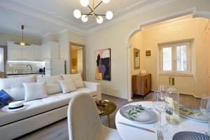 a living room with a white couch and a table at Island Suite, Old Town in Corfu