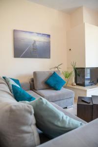 a living room with a couch and a chair at Solari Hill Maisonette two private parking in Corfu