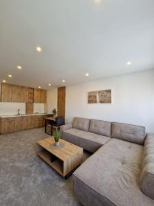a living room with a couch and a table at Apartmani Maksa in Stanovo