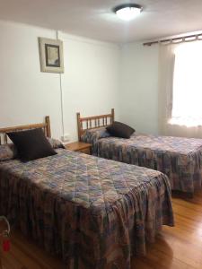 a hotel room with two beds and a window at Apartamento Forn de Serra in Lladorre