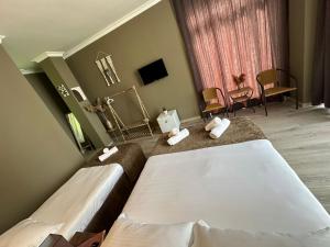 a hotel room with two beds and a tv at WoodSea in Batumi