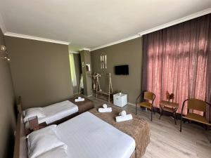 a hotel room with two beds and a window at WoodSea in Batumi