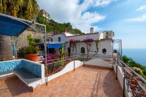 a house with a balcony with a view of the ocean at Charming Villa, with terrace overlooking the sea, Amalfi coast, 170 steps from the road in Conca dei Marini