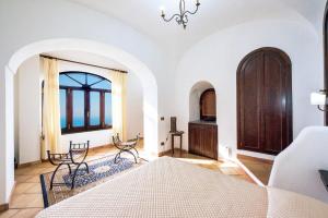 a bedroom with a bed and chairs in a room at Charming Villa, with terrace overlooking the sea, Amalfi coast, 170 steps from the road in Conca dei Marini +34 photos