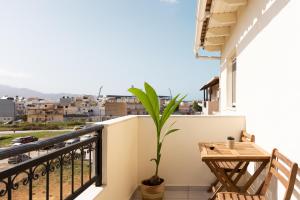 a balcony with a table and a plant at S12 Apartments in Heraklio