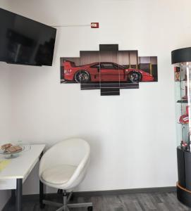 a room with a desk and a red car on the wall at Il Cavallino, sul lago Ceresio in Brusimpiano