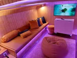 a living room with a couch and a tv at SLEEPBOAT LuxLife Yatch in Porto