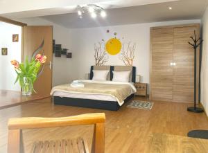 ブラショヴにあるSun Studio in Old Town Center - Quiet & Cozyのベッドルーム1室(ベッド1台、花瓶1本付)
