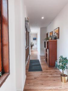 a hallway with white walls and wooden floors at Blue Lotus Hotel & Hostel in Bratislava