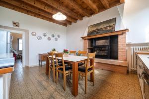 a dining room with a table and a fireplace at Antico Stemma Corte Meneghella in Monzambano