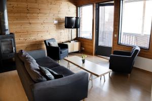 a living room with a couch and two chairs and a table at Ameno 3 Himos by DG Lomailu in Jämsä