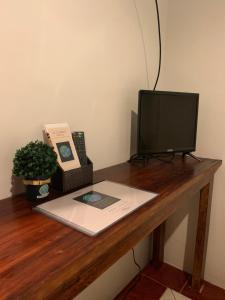 a desk with a computer and a television on it at LS Garden Villa in Puerto Princesa City