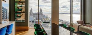 einen Konferenzraum mit einem Tisch und Stühlen vor den Fenstern in der Unterkunft The Becky Suite - Princes Dock Liverpool in Liverpool