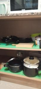 a shelf with some pots and pans on it at Bonito bajo cerca del mar in Benicarló +37 photos