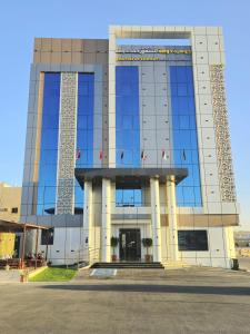 un gran edificio con muchas ventanas en جوهرة دومة الجندل للشقق المخدومة Jawharat Dumat Serviced Apartments en Dawmat al Jandal