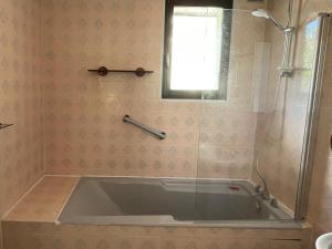 a bath tub in a bathroom with a shower at Green Nest - Metro line 7 in La Courneuve +15 photos