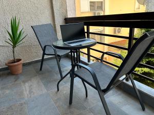 a laptop computer sitting on a table on a balcony at Park Apartment in Neoi Epivates