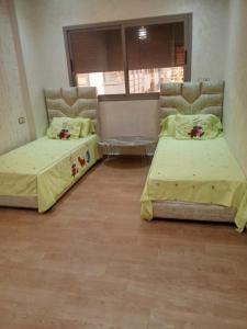 two beds sitting in a room with at بوزنيقة in Bouznika