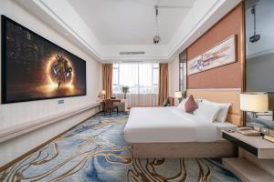 a hotel room with a bed and a large screen at Guangzhou Yunshang Airport Hotel Free shuttle airport bus in Guangzhou