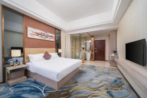 a hotel room with a bed and a television at Guangzhou Yunshang Airport Hotel Free shuttle airport bus in Guangzhou