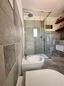 a bathroom with a shower and a toilet and a sink at Villa Peru in Tanaunella