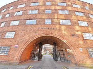 a large brick building with an archway at For Students Only Pirvate Ensuites and Non-Ensuite Rooms with Shared Bathroom at St Andrews Gardens in Liverpool in Liverpool