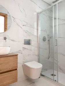 a bathroom with a shower and a toilet and a sink at Casa da Eira by Quantique in Amares