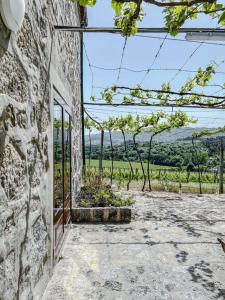 a stone building with a window and a tree at Casa da Eira by Quantique in Amares