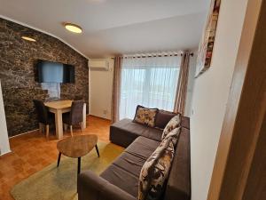 a living room with a couch and a table at Dom M Apartments in Budva
