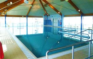 a large swimming pool in a large building at Caravan home Clacton-On-Sea St Osyth in Saint Osyth