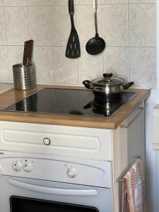 a kitchen with a stove with a pot on it at Green Nest - Metro line 7 in La Courneuve