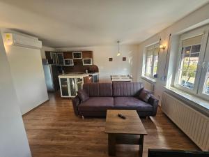 a living room with a couch and a coffee table at Na Rynku in Ślesin