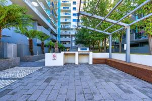 a building with a table with a laptop on it at Spacious and Cosy Apt with Great Views in Braddon - Hosted by CanStay in Canberra