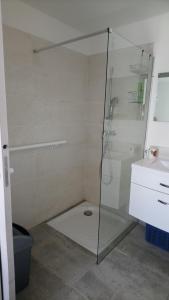 a shower with a glass door in a bathroom at Chez Chris et Marie in Les Mages +21 photos