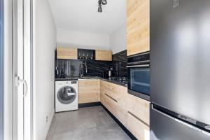 a kitchen with a stainless steel refrigerator and a dishwasher at Le Hammam in Nice