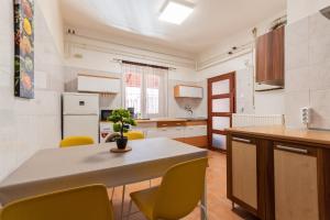 a kitchen with a table and yellow chairs at K52 Apartment Budapest in Budapest