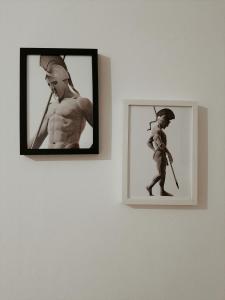 two pictures of a man and a woman on a wall at Spartan Townhouse Apt 3 Leonidas in Sparti